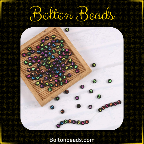 Close-up of Alphabet Beads in Black Neon (Round) 7mm for jewelry making.