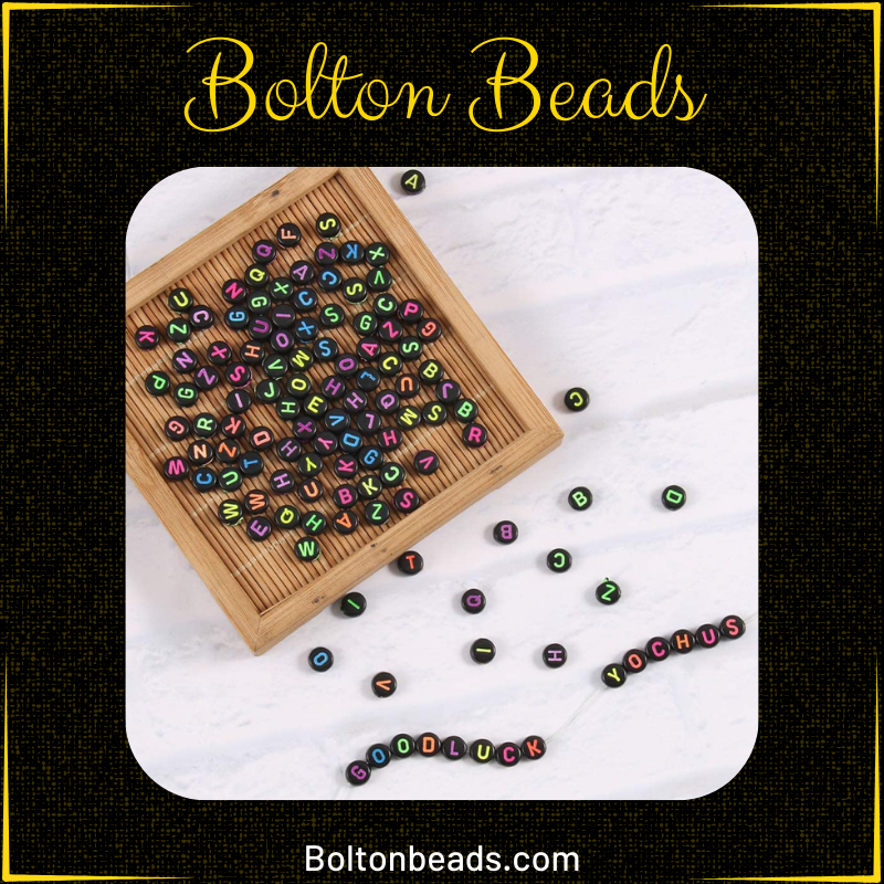 Close-up of Alphabet Beads in Black Neon (Round) 7mm for jewelry making.